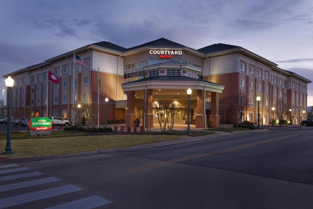 ein Gebäude mit einem Schild auf der Vorderseite in der Unterkunft Courtyard by Marriott Fort Smith Downtown in Fort Smith