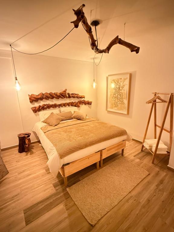 a bedroom with a large bed with a wooden headboard at Cas'A Ferreirinha - Your Home In Douro in Peso da Régua