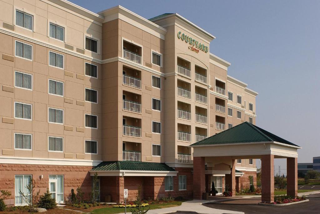 un bâtiment d'hôtel avec un kiosque devant lui dans l'établissement Courtyard by Marriott Toronto Markham, à Markham