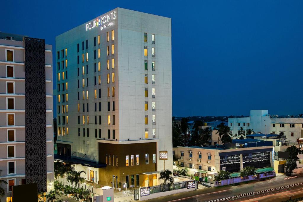 a tall building with a sign on the side of it at Four Points by Sheraton Chennai OMR in Chennai