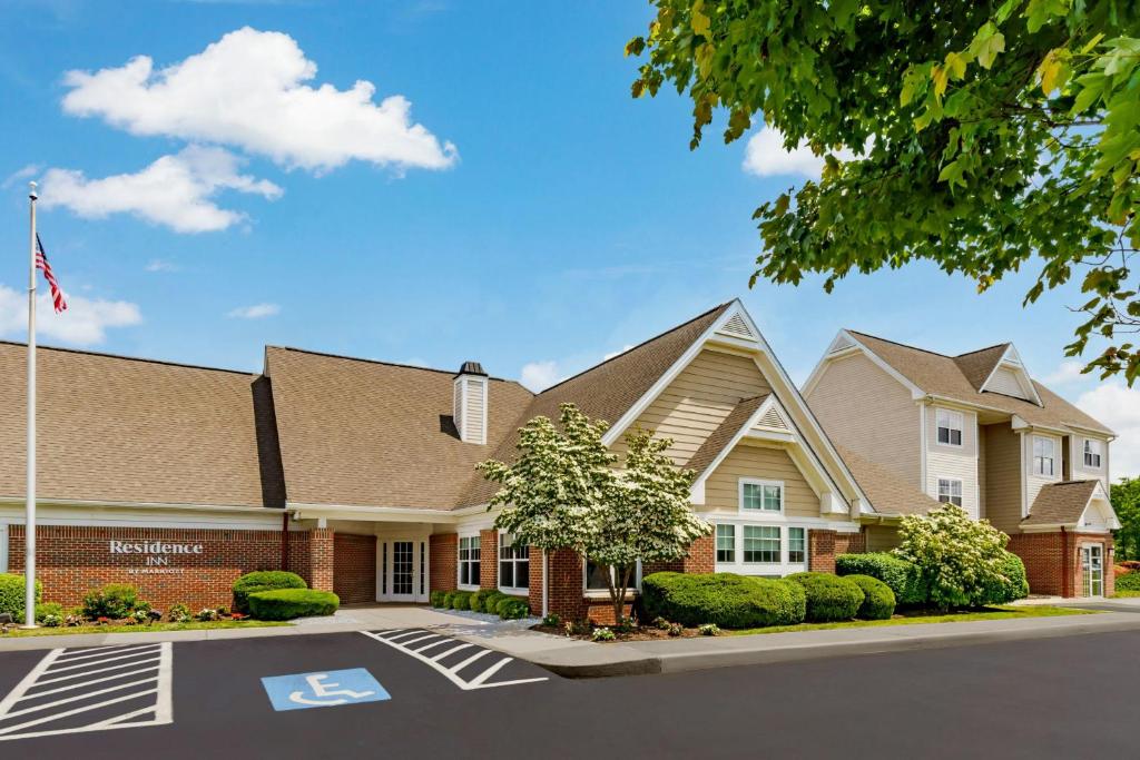 a building with an american flag in front of it at Residence Inn Hartford Rocky Hill in Rocky Hill