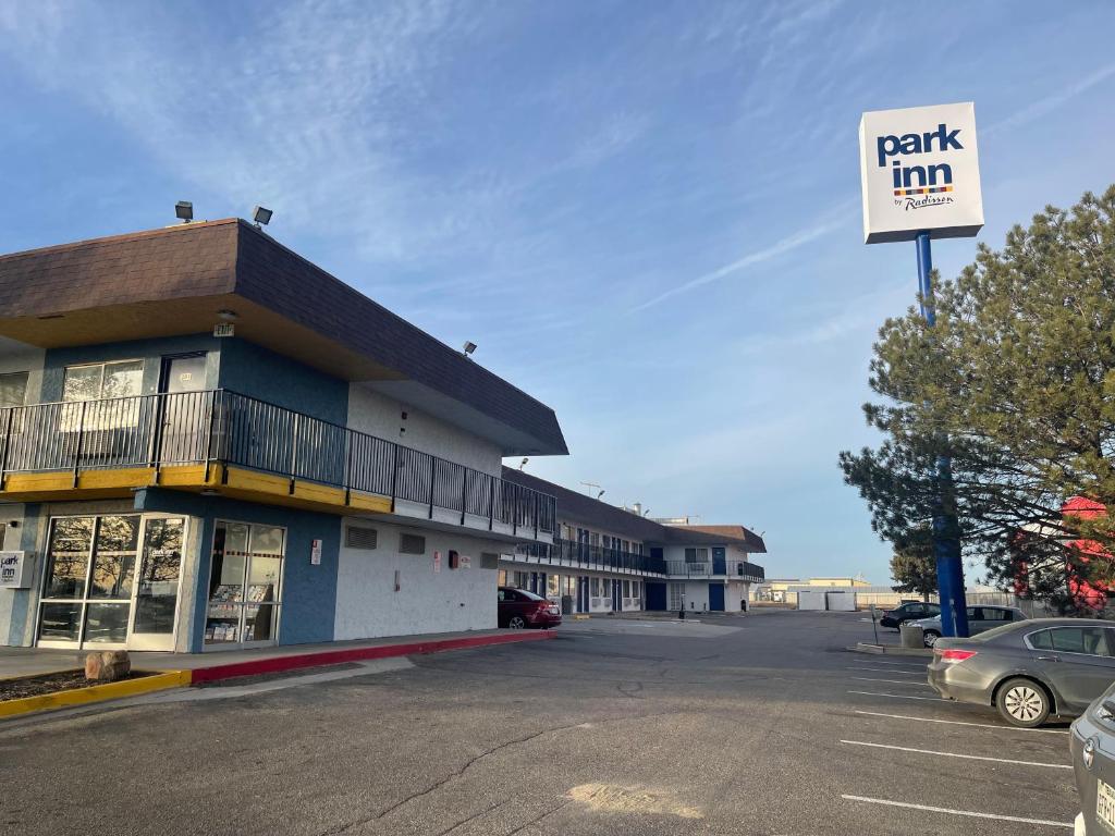 a parking lot in front of a building with a parking inn sign at Park Inn by Radisson, Fort Collins in Fort Collins