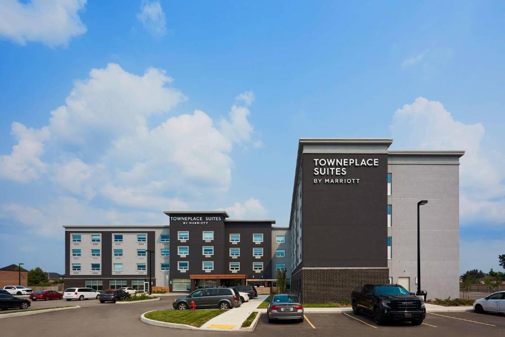 a building with cars parked in a parking lot at TownePlace Suites by Marriott Hamilton in Hamilton