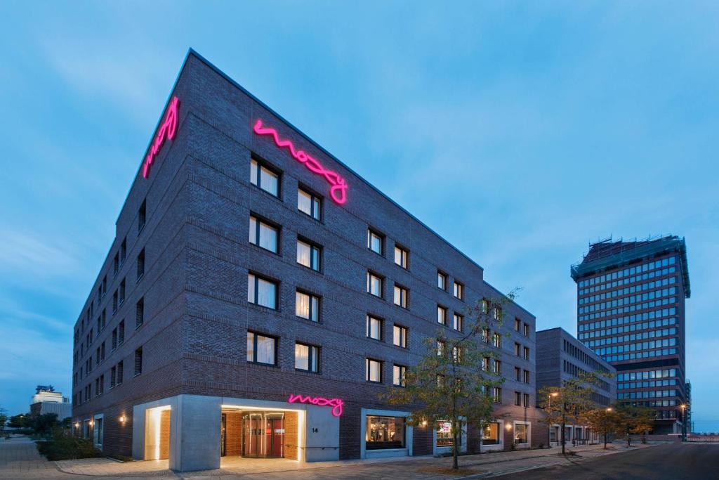 a building with a sign on the side of it at Moxy Bremen in Bremen