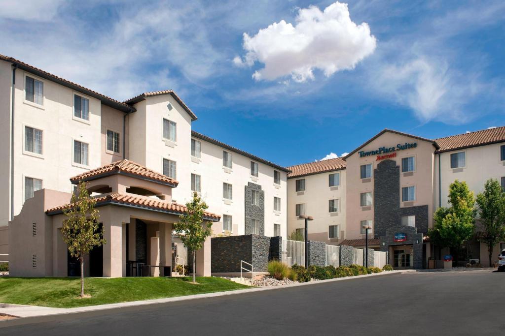 a row of apartment buildings with a street at TownePlace Suites by Marriott Albuquerque Airport in Albuquerque