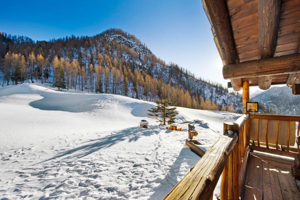 a view from the porch of a cabin in the snow at Chalet L'Ange Des Neiges in Valtournenche