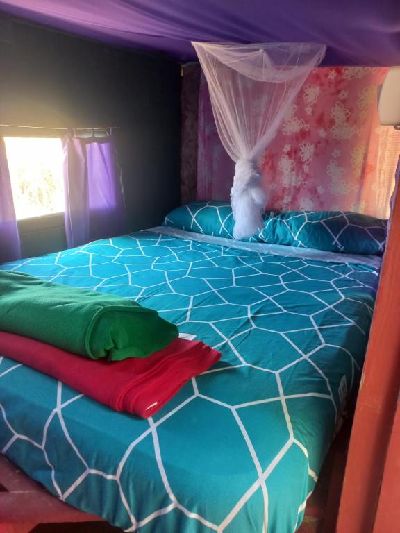 a bedroom with a bed with a canopy at Ajo Aloha Hostel in Cabo Polonio