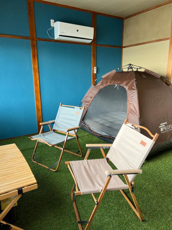 two chairs and a tent in a room at ASTERISK＋ in Iwami