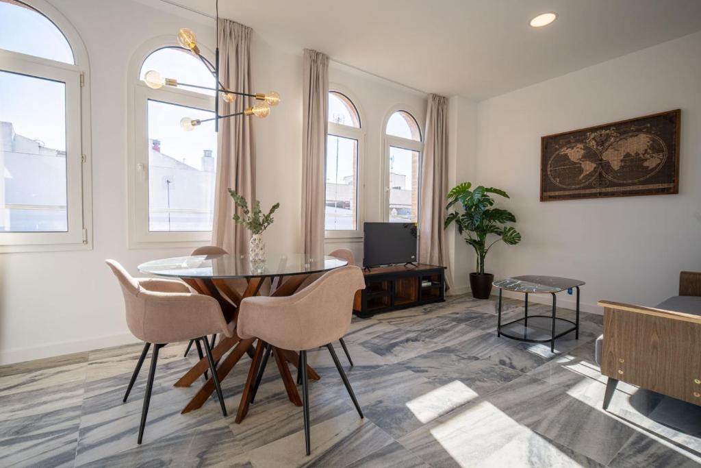 a living room with a table and chairs at William Martin Apartments in Huelva