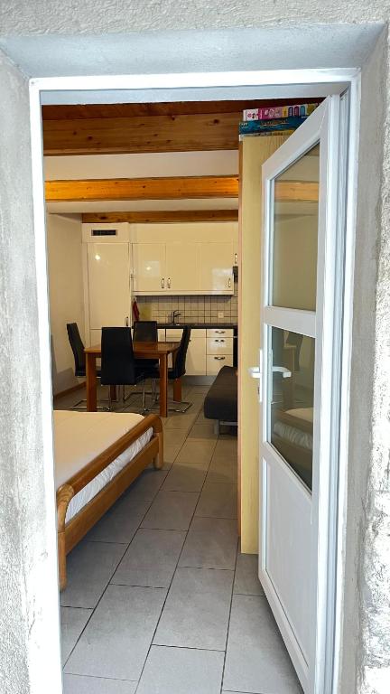 a view of a room with a bed and a table at Quiet Flat in Nature in Lugano in Lugano