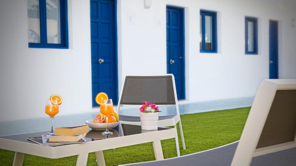 a table and chairs with drinks on a patio at Corralejo Lodge in Corralejo