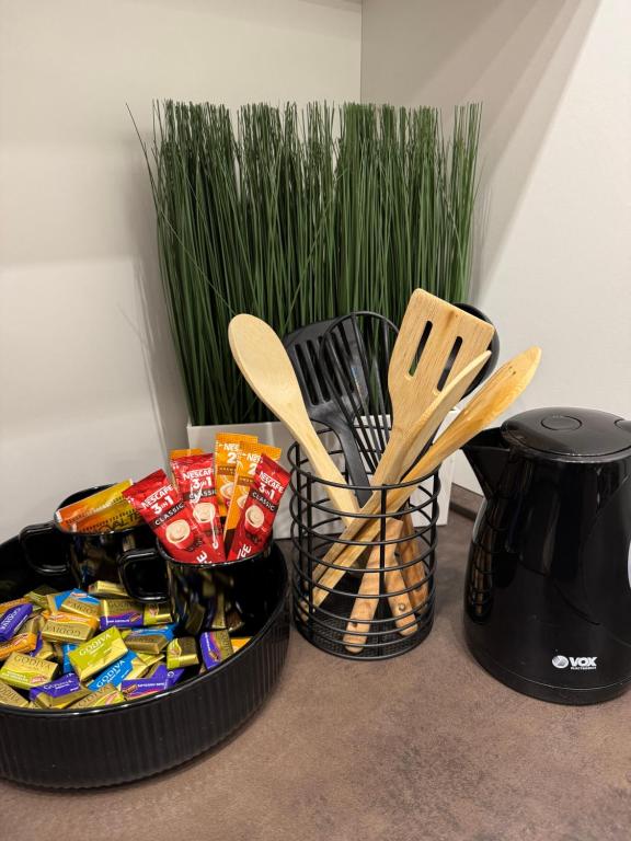 a basket of food and utensils sitting next to a table at Premium Line Apartman in Sombor