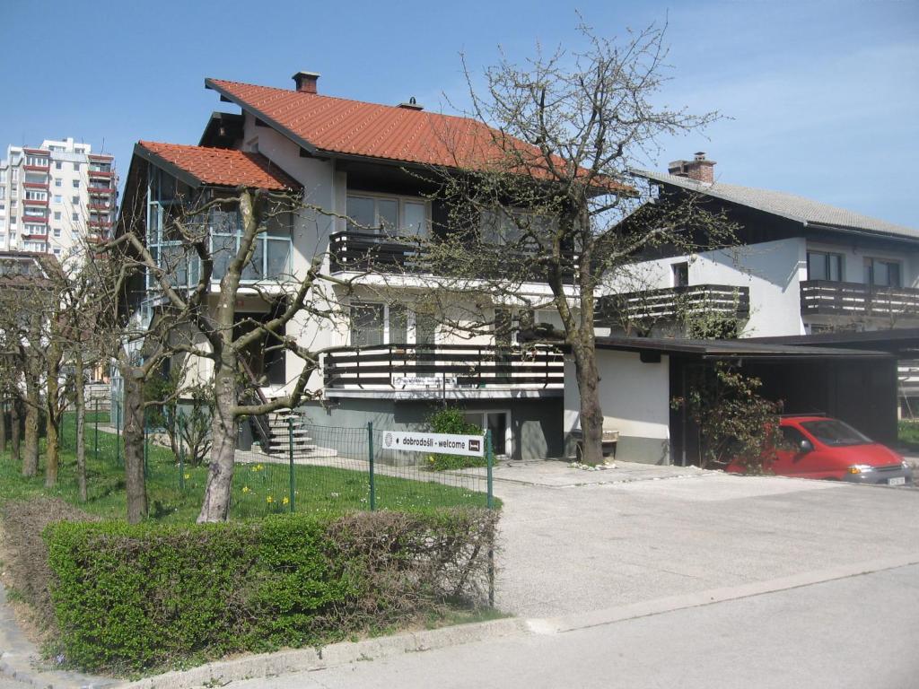 un gran edificio blanco con techo rojo en Rooms and Apartment Na poljani, en Škofja Loka