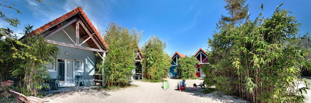 una casa sulla spiaggia con alberi di fronte di Naturotel a Fort-Mahon-Plage