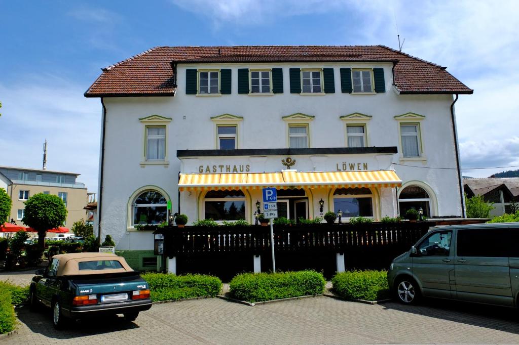 una casa blanca con un coche aparcado delante de ella en Hotel Löwen, en Kirchzarten