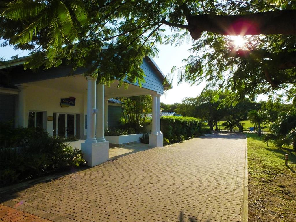 a building with a brick walkway in front of it at Premier Splendid Inn Bayshore in Richards Bay