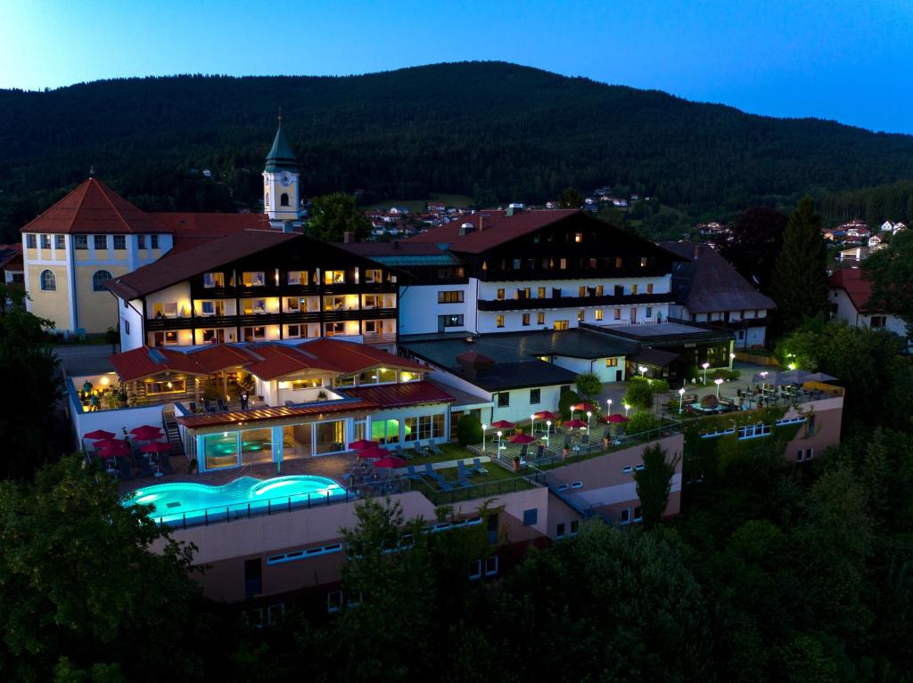 un grande edificio con luci accese di notte di Wellnesshotel Hofbräuhaus a Bodenmais