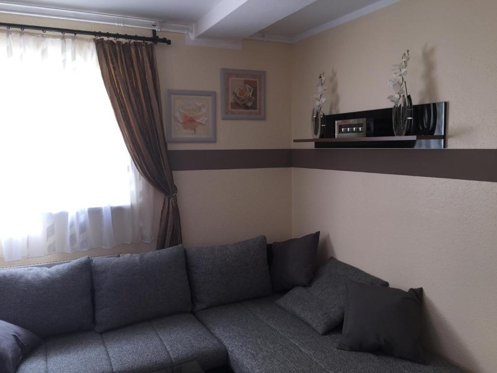 a living room with a couch and a window at Boulevard Apartment in Raunheim