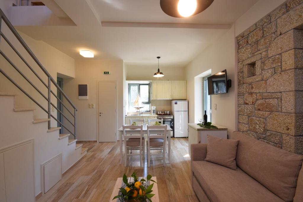 a living room with a couch and a stone wall at Kastro-Kardamili in Kardamili