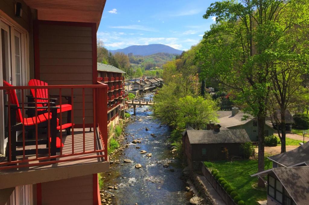 a view of a river from a balcony of a house at Baymont by Wyndham Gatlinburg On The River in Gatlinburg