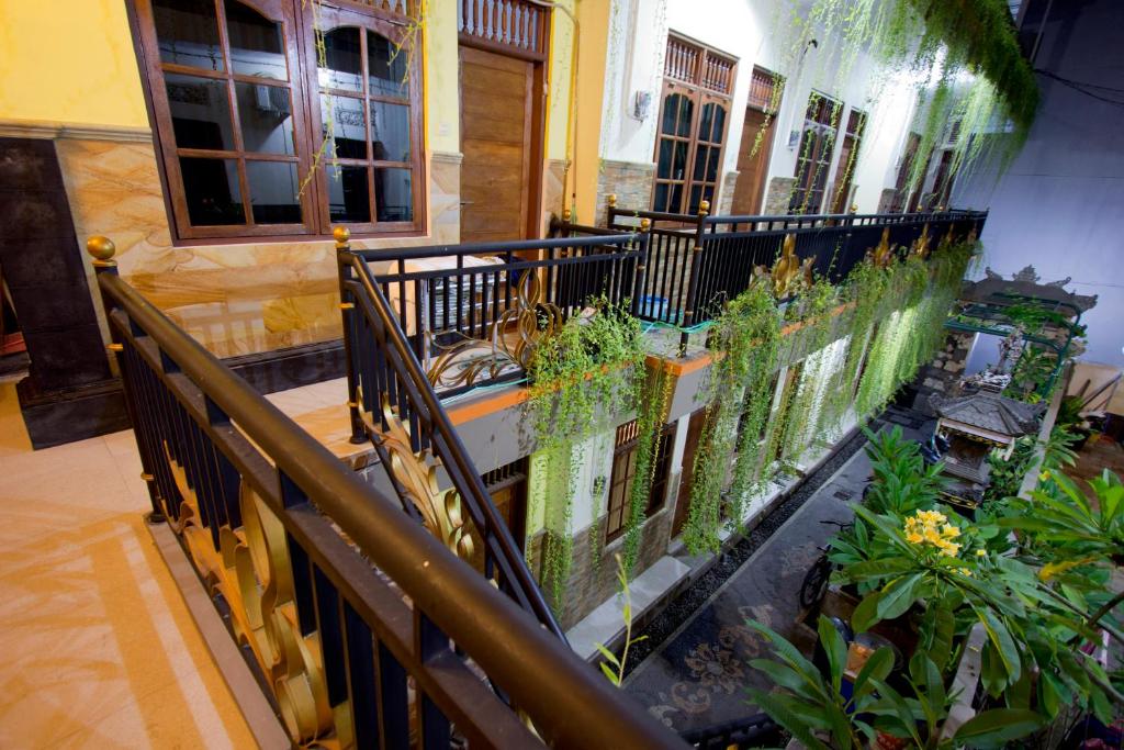 a balcony of a building with plants on it at Asta House in Kuta