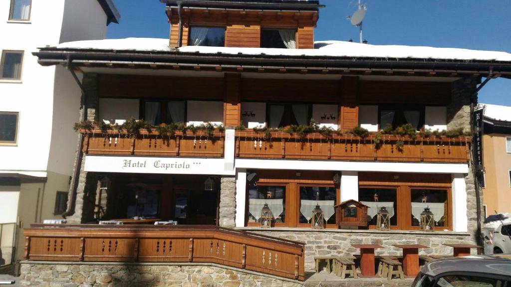 un gran edificio con un balcón en la parte superior. en Hotel Capriolo, en Madesimo