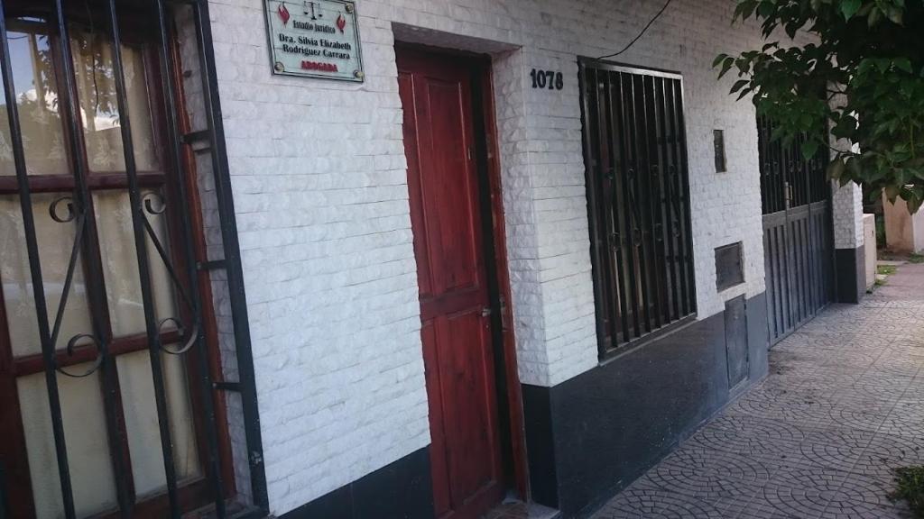 a red door on the side of a building at Departamento Libertad in San Salvador de Jujuy