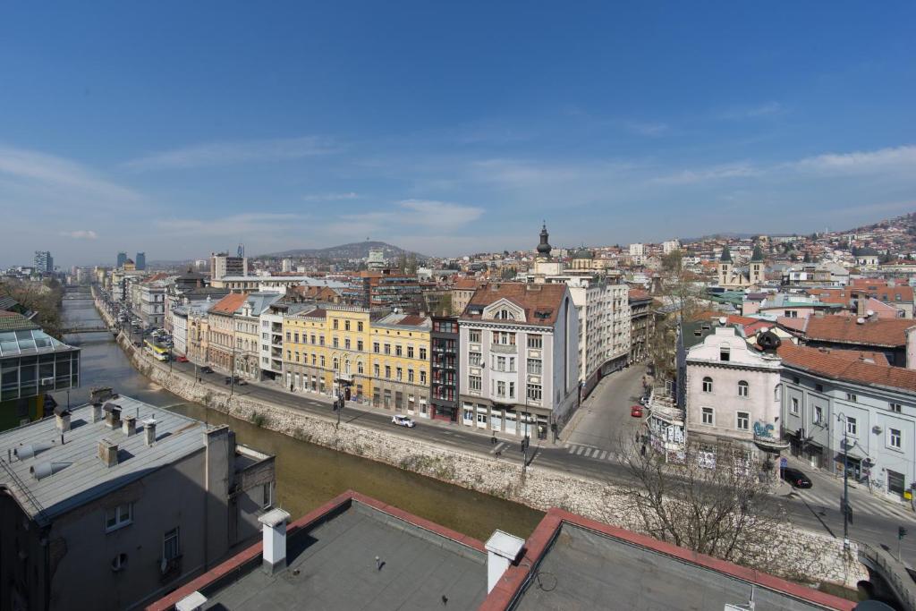 a view of a city with a river and buildings at Amazing Penthouse old town in Sarajevo