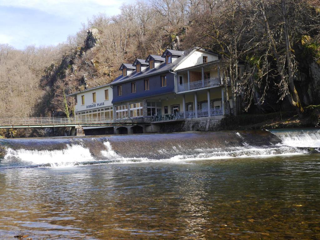 uma casa ao lado de um rio em Hotel Dirbach Plage em Dirbach