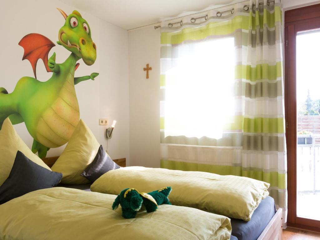 a bedroom with two beds with a toy dinosaur on them at Ruster Drachennest in Rust