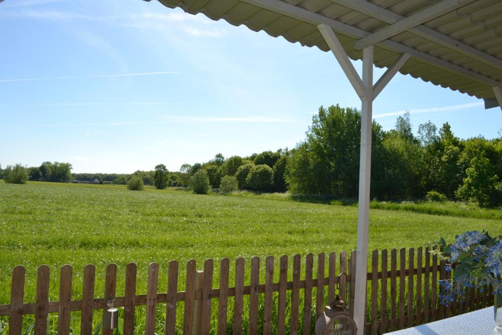 una valla con un campo en el fondo en Bed & Breakfast Boszicht Leeuwarden, en Leeuwarden