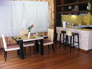 a kitchen with a table and chairs and a counter at Baan Nana Villa in Mae Nam