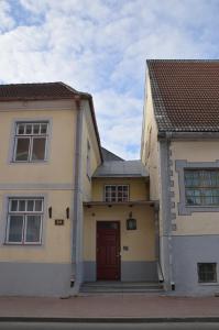 a house with a red door and two buildings at Kuninga City Center Apartment in Pärnu