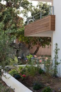 een tuin met een balkon aan de zijkant van een gebouw bij Résidence Hôtelière Alcyon in Porto-Vecchio