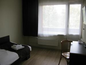 A bed or beds in a room at Hotel Dobele