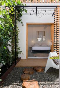 a view of a bedroom from a garden with a bed at Sodium Boutique Hotel in Ciutadella