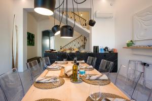 a dining room with a long table with bottles and chairs at Sodium Boutique Hotel in Ciutadella