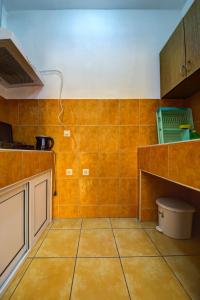 a kitchen with orange tiles on the wall and a counter at Apartments Dalila in Ulcinj