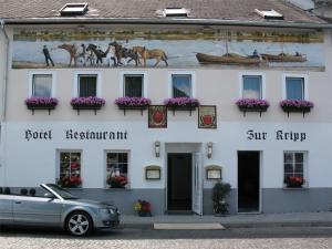 a car parked in front of a white building at Hotel Zur Kripp in Koblenz