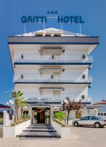 a hotel with a car parked in front of it at Hotel Gritti in Lido di Jesolo