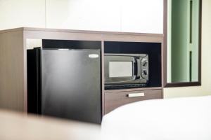 a kitchen with a microwave and a refrigerator at Inns of Virginia Arlington in Arlington