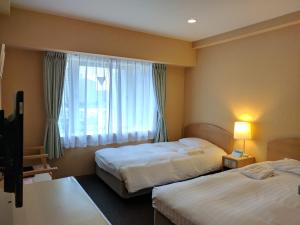 Giường trong phòng chung tại Hotel Harbour Yokosuka