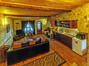 a large living room with a couch and a kitchen at Adanos Konuk Evi in Avanos