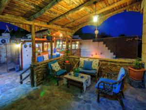 a patio with chairs and a table and a fireplace at Adanos Konuk Evi in Avanos