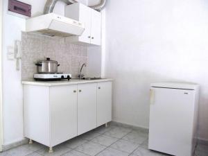 A kitchen or kitchenette at Pagona Hotel