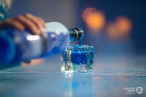 a bottle of water being poured into a glass at Sorrisniva Igloo Hotel in Alta