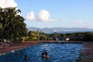 a swimming pool with people in the water at Villa Viuli in Torre del Greco