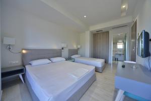 Giường trong phòng chung tại Hotel Kakanakos