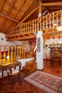 a living room with a wooden staircase and a table at Casa D Obidos in Óbidos