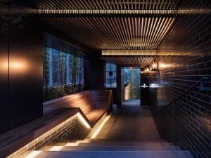 a hallway of a building with benches and a window at Kyoto Granbell Hotel in Kyoto